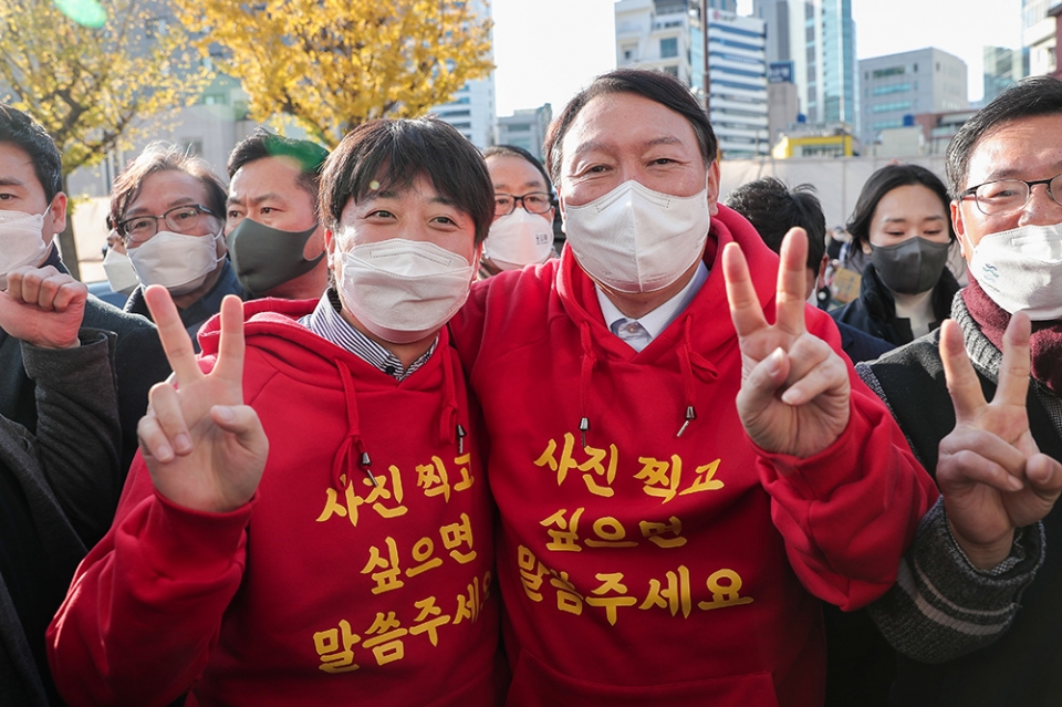 4日、釜山市内でおそろいのパーカーを着て選挙活動を行う国民の力の尹錫悦候補（右）と李俊錫代表。国民の力提供。